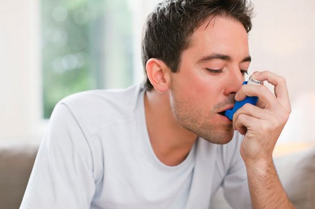 man-using-asthma-inhaler