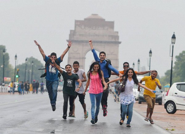 New Delhi: Youngsters enjoying the pre-monsoon showers at India Gate in New Delhi on Saturday. PTI Photo by Shahbaz Khan (PTI6_13_2015_000092B)
