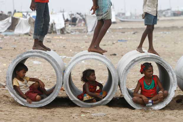 children-inside-water-pipes-marina-beach-chennai-india